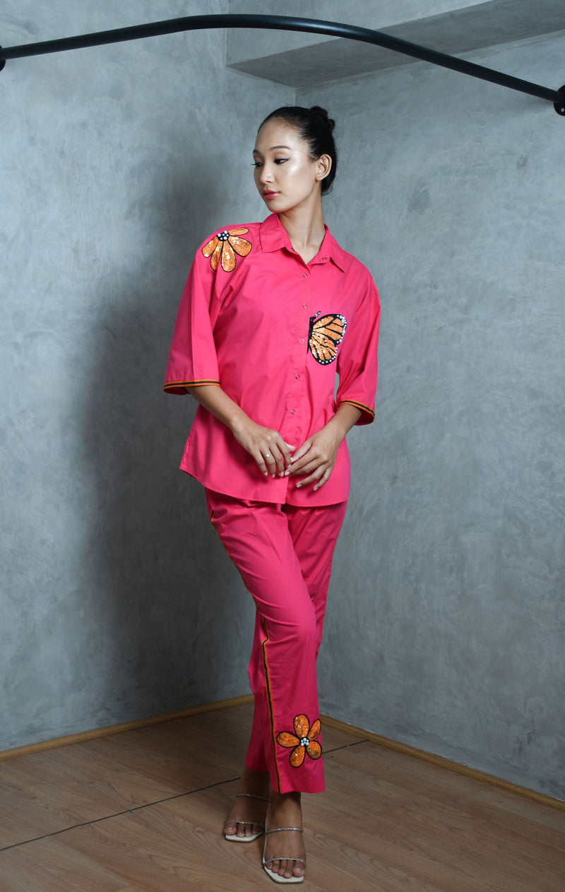 Hot pink cotton shirt with hot pink straight pants.