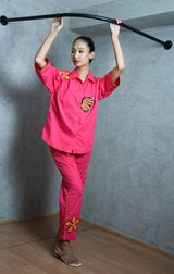 Hot pink cotton shirt with hot pink straight pants.